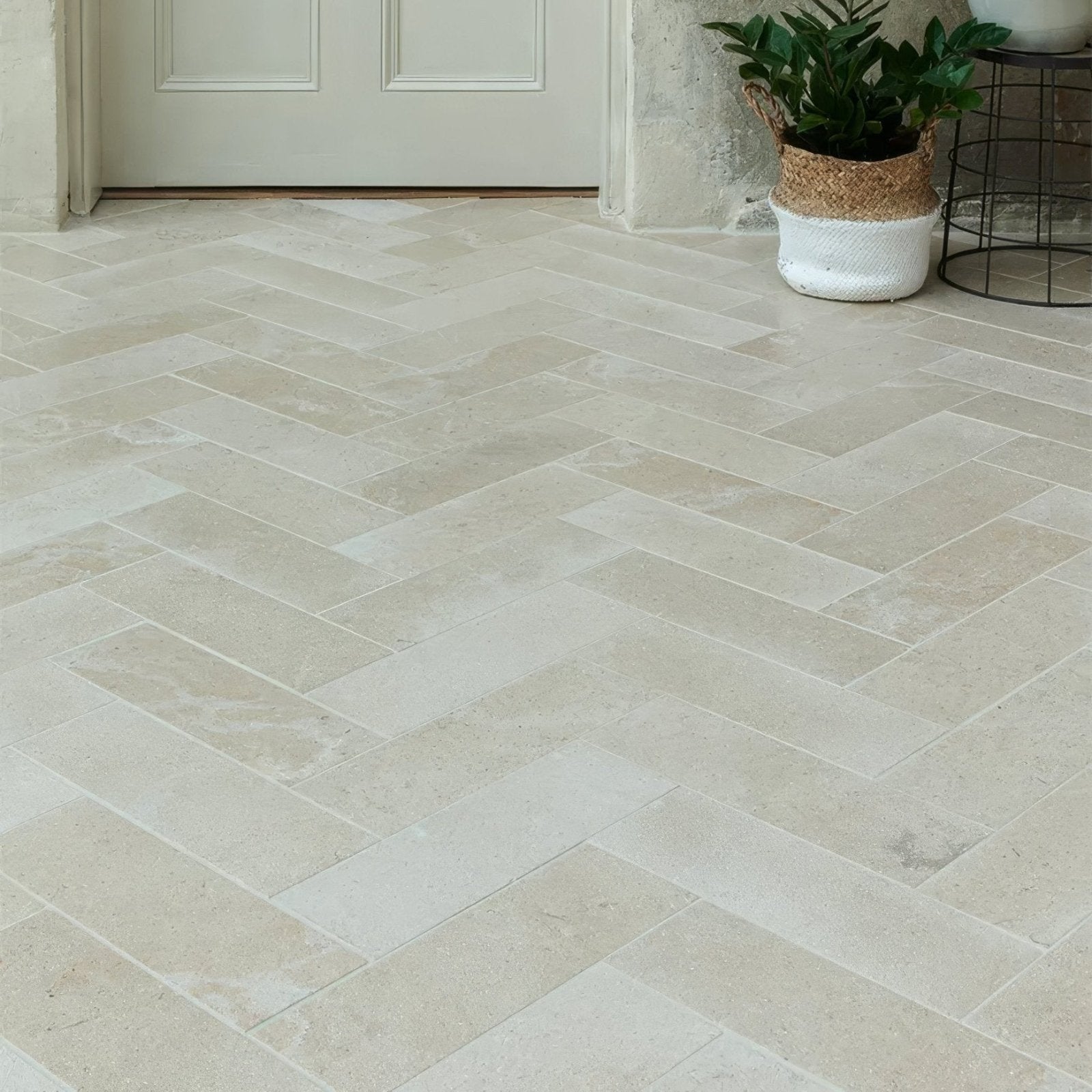 Beige herringbone patterned buscot limestone brick velvet finish stone floor tiles with a smooth texture