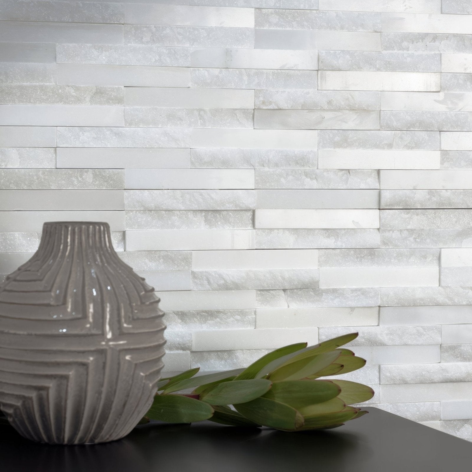 Gray ceramic vase with geometric ridged design from the Neve linear stone mosaic collection