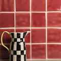 New Burgundy Field Tile ceramic pitcher with black and white checkered pattern and yellow handle for serving beverages