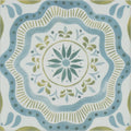 A square ceramic Nina Campbell Cochin blue porcelain tile with a hand-painted blue and olive green floral mandala design