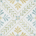 White ceramic porcelain tile with delicate botanical pattern in sage green muted blue and pale yellow by Nina Campbell
