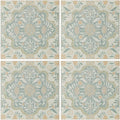 Four square Nina Campbell Jodhpur Aqua porcelain tiles with delicate sage green and peach floral patterns on off-white background