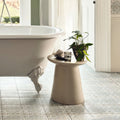 Beige ceramic pedestal table with smooth matte finish and tapered design shown with nina campbell jodhpur aqua porcelain tile