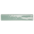 A rectangular ceramic wall tile with a matte muted sage green glaze and subtle white streaks by nina campbell rivage aqua