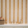 The bathroom wall features Nina Campbell Rivage ivory glazed wall tiles in glossy cream and warm amber vertical rectangles