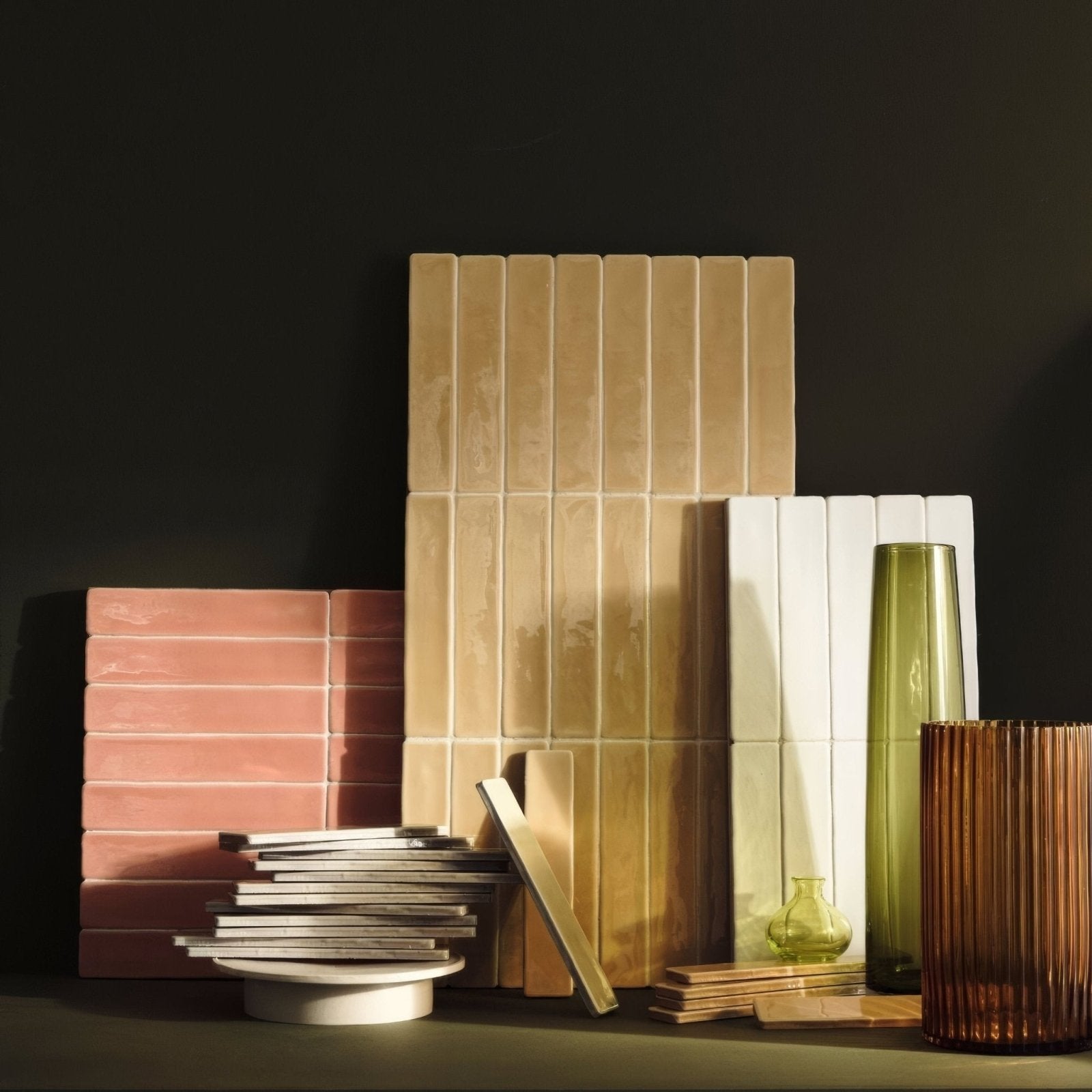 Stack of rectangular beige ceramic nina campbell rivage ochre glazed wall tiles with vertical grooves and matte finish