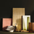 Stack of rectangular beige ceramic nina campbell rivage ochre glazed wall tiles with vertical grooves and matte finish