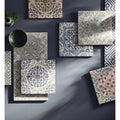 Square porcelain tile with intricate floral and geometric patterns in muted blues gray beige and red by Nina Campbell