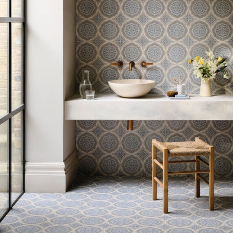 Beige stone vessel sink with minimalist modern design featured with nina campbell udaipur blue porcelain tile background