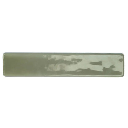 A rectangular ceramic wall tile by nina campbell with matte sage green glaze and subtle lighter patches