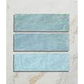 Three rectangular turquoise ceramic tiles with a matte slightly textured finish from oasis ceramic aqua gloss collection