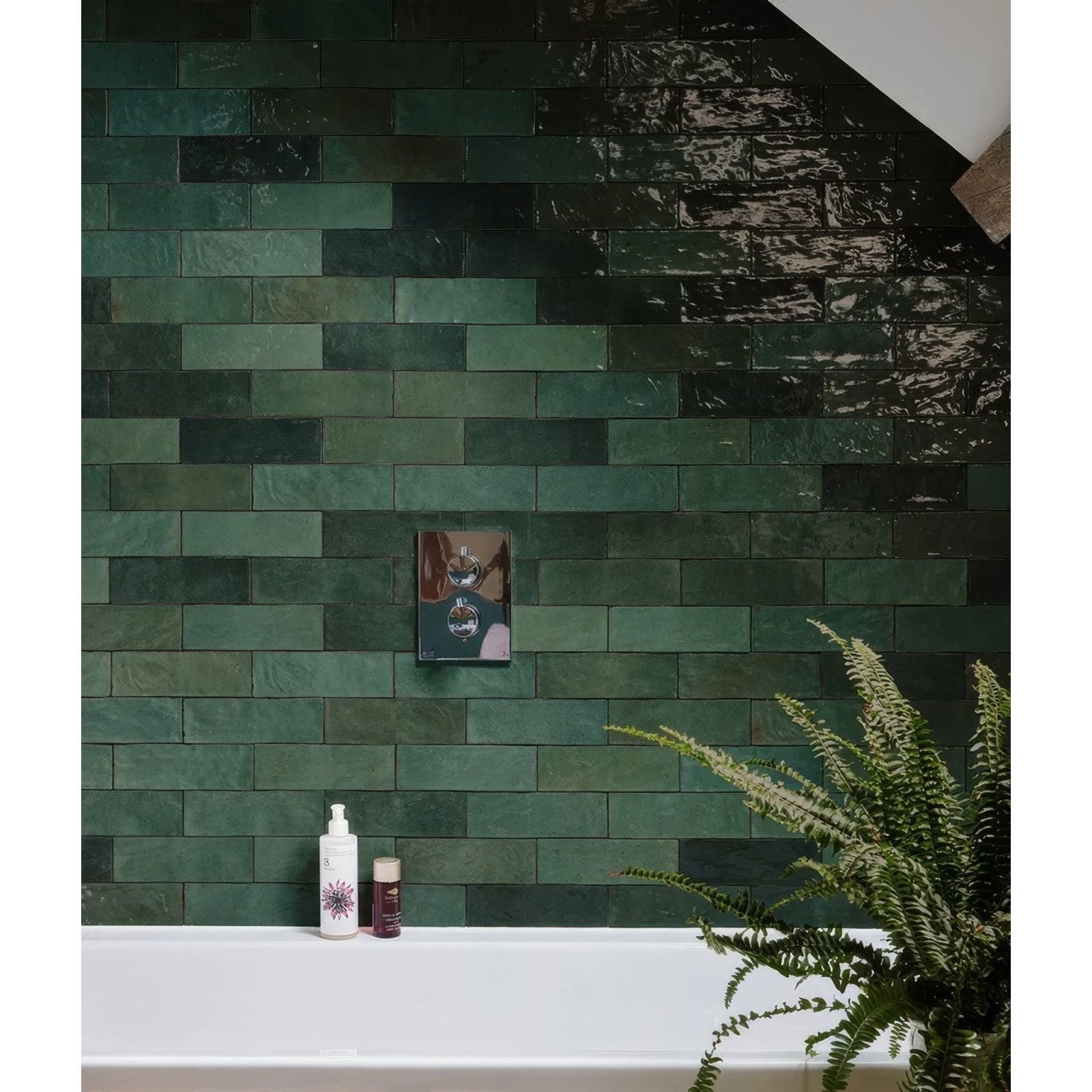 A sleek rectangular chrome finished shower control panel with a circular dial and two buttons for oasis ceramic green gloss