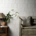 White textured rectangular ceramic tiles cover the wall in oasis veloute ceramic white matt design