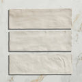Three rectangular off-white ceramic tiles with textured matte finish from oasis veloute ceramic white matt collection