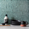 Oasis Glass Mosaic emerald green glass mosaic with a black ceramic mug