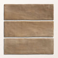Three rectangular taupe ceramic tiles with a matte textured finish from oasis veloute ceramic tan matt collection