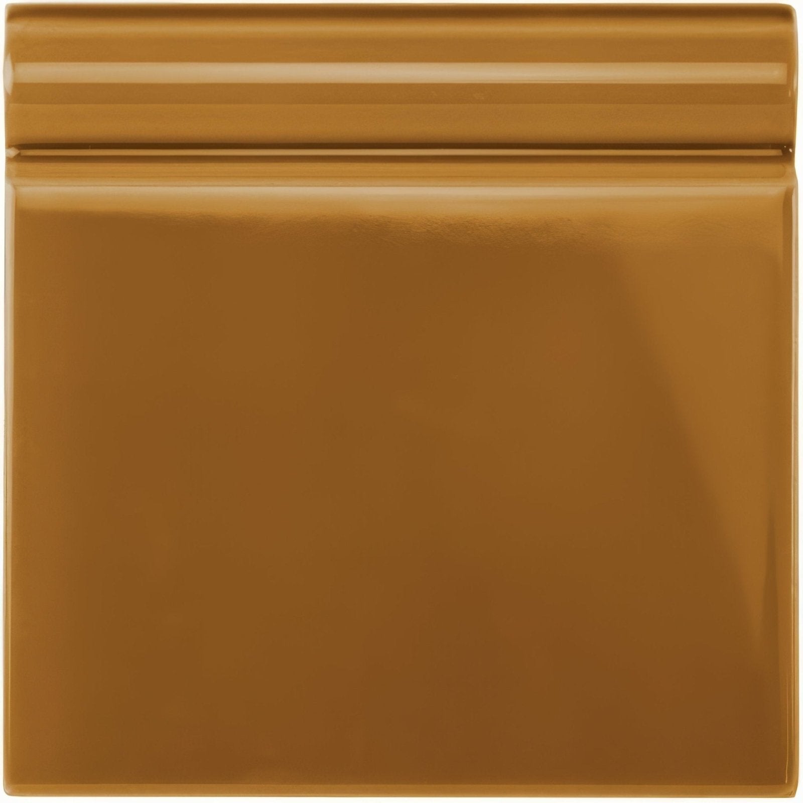A glossy bronze ceramic ochre skirting tile with a smooth reflective surface and subtle horizontal ridges on top edge