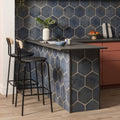 Dark blue hexagonal tile backsplash with metallic gold grout lines from oken hexagon blue collection