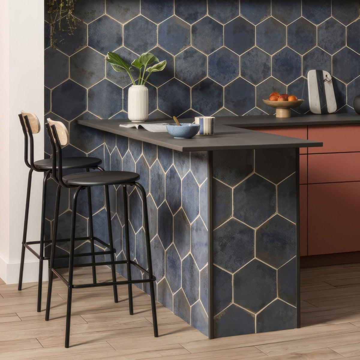 
Dark blue hexagonal tile backsplash with metallic gold grout lines from oken hexagon blue collection