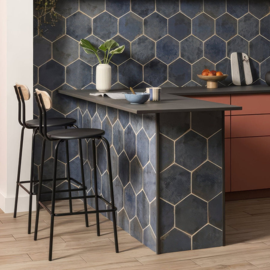 Dark blue hexagonal tile backsplash with metallic gold grout lines from oken hexagon blue collection