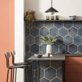 Dark blue oken hexagon blue ceramic tiles with metallic grout lines used as a modern kitchen backsplash