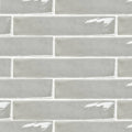 Onda chamelon wall tiles in gray glass subway style with a glossy finish and subtle white grout lines