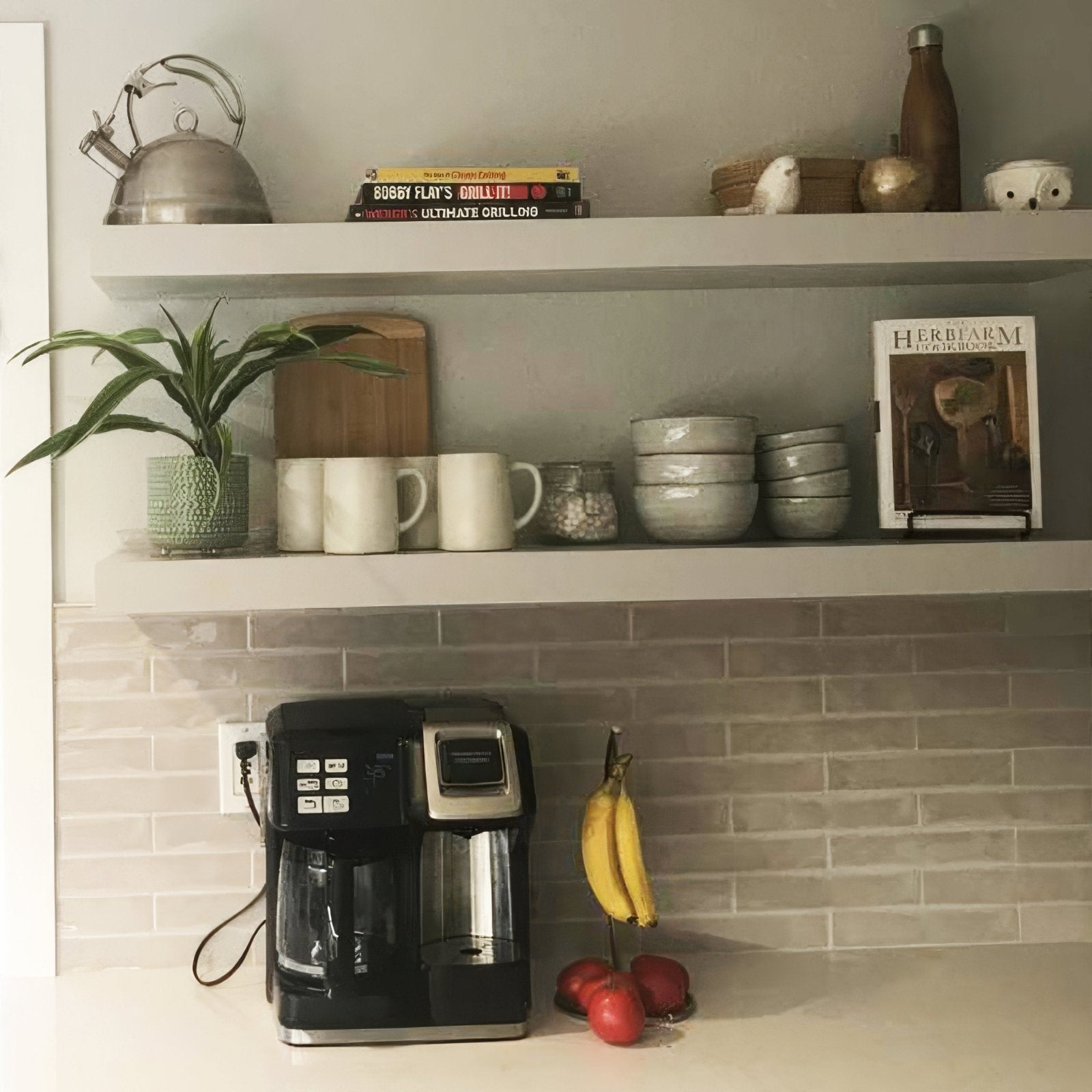 Black and silver coffee maker with glass carafe placed on Onda hibiscus wall tiles for kitchen decor