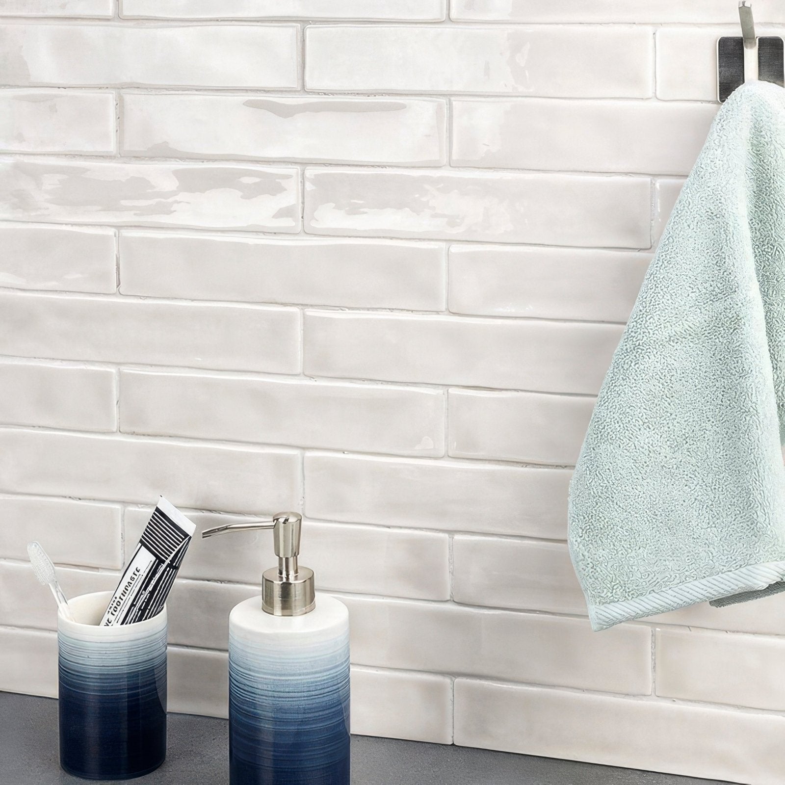 Ombre blue and white ceramic soap dispenser with sleek metallic pump for onda hisbiscus wall tiles display
