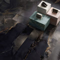 Onyx Black in Polished and Matt Tiles dark grey marble-effect tiles with a silver handbag on a pedestal
