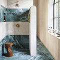 Onyx Ivory Marble Effect Tile white marble-effect tiles with a rustic wooden stool