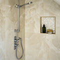 Onyx Ivory Matt Marble Effect Tile 60 x 120 white marble-effect tiles with a chrome showerhead