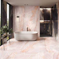 Onyx Pink in Polished and Matt Tiles pink marble-effect tiles with a freestanding bathtub