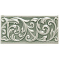 A rectangular ceramic Orford Buckingham tile with raised scrollwork design in matte sage green glaze