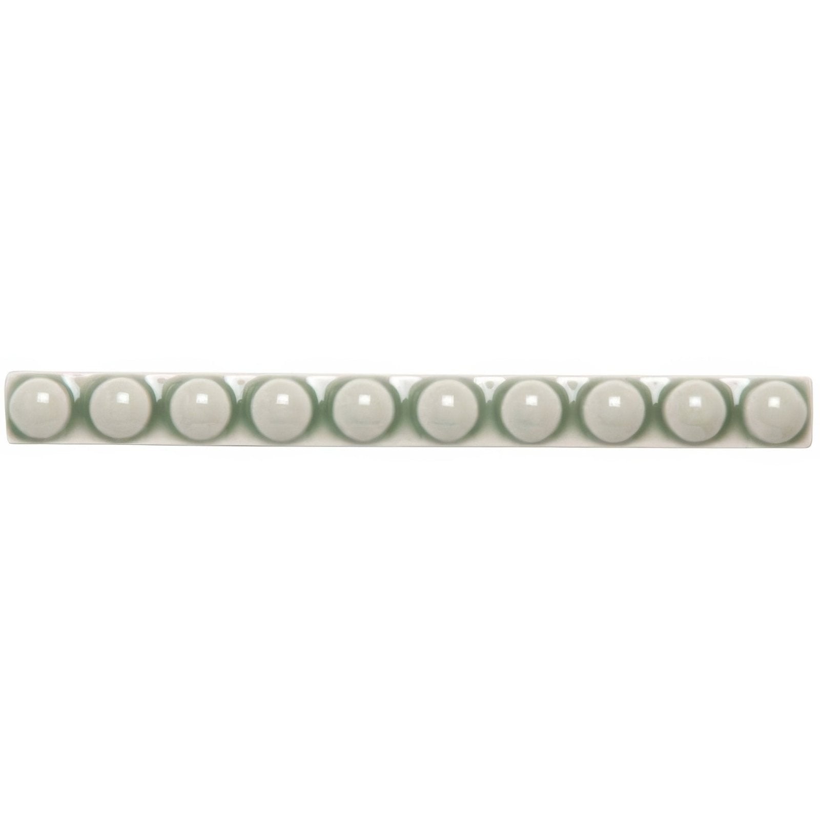 A row of ten glossy white spherical beads made of smooth material in a linear arrangement from orford empire