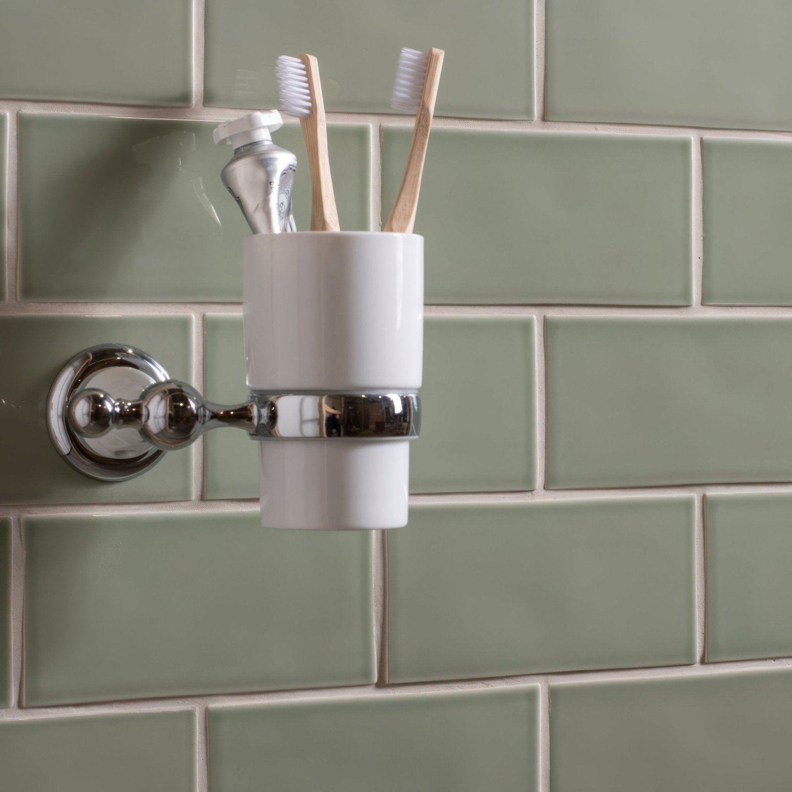White ceramic toothbrush holder with chrome-finished wall mount designed for bathroom use orford half tile style