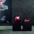 Orion 30 x 30cm black glossy mosaic tile with two burgundy handbags