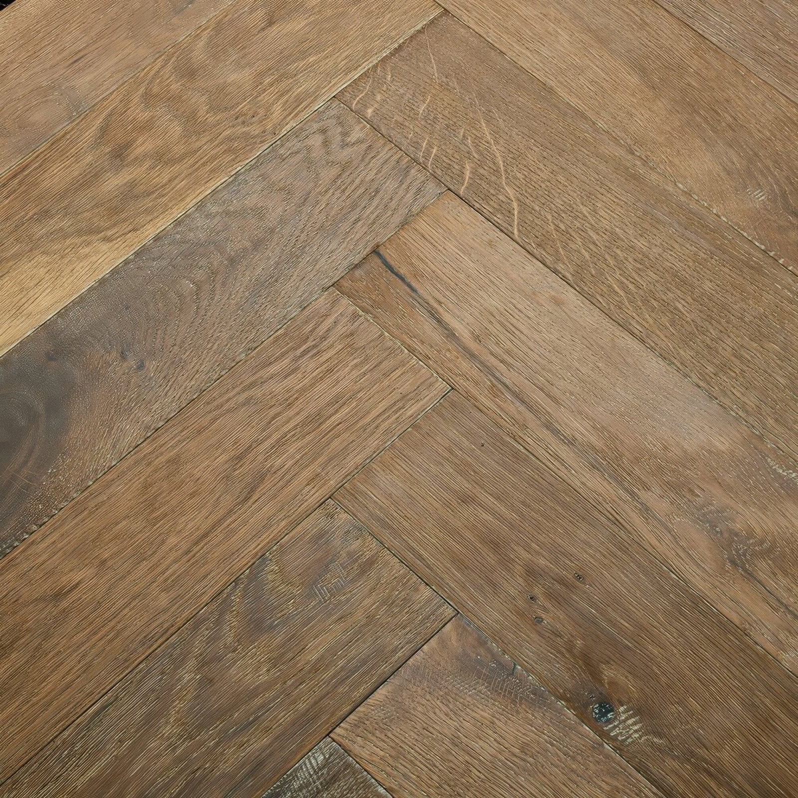 Warm-toned oak hardwood flooring in a classic herringbone pattern from orkney marbled oak collection