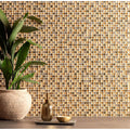 Gold-toned orla glass and stone mosaic tile wall with textured shimmering finish for decorative interiors
