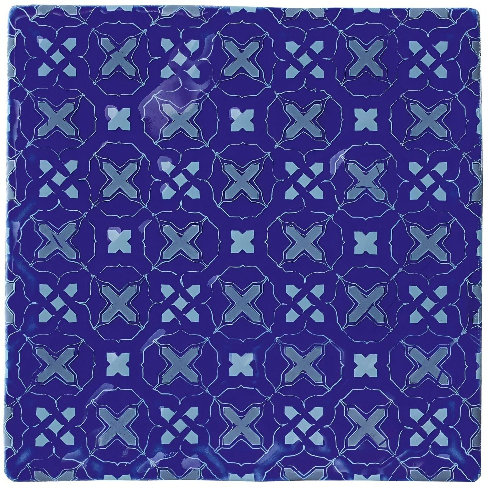 Deep blue ceramic tile ormeaux on amun with a repeating geometric pattern of lighter blue x-shapes and diamond accents