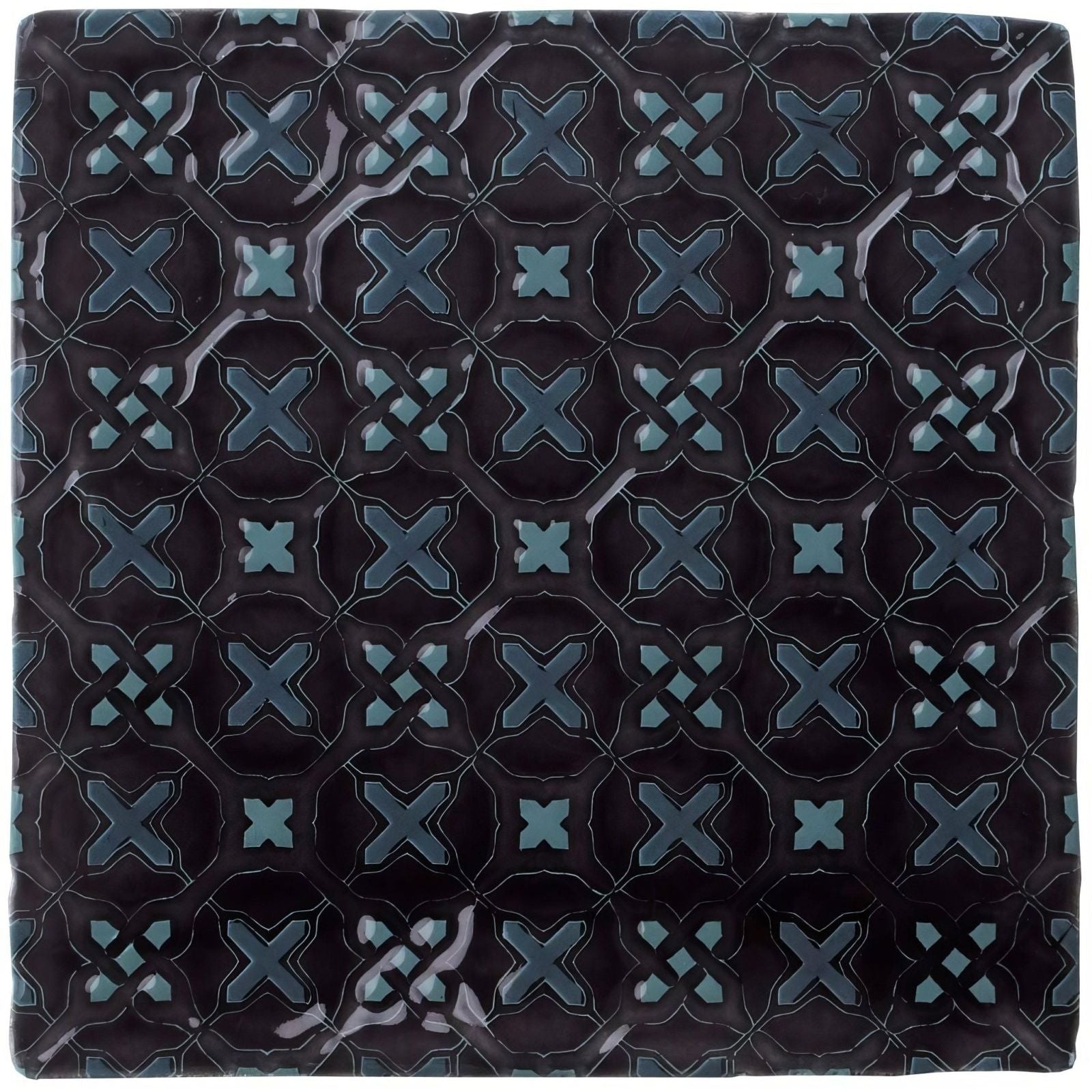 Dark blue ceramic tile ormeaux on sloe with glossy finish and intricate teal geometric x-shape pattern