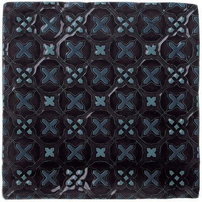 Dark blue ceramic tile ormeaux on sloe with glossy finish and intricate teal geometric x-shape pattern