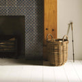 A natural-toned wicker basket with twisted handles filled with firewood from ormeaux on truffle collection