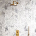 Ottimo Curve Mosaic white marble curved mosaic with a gold showerhead
