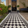 Black and white checkered tiled pathway made of oxford 106mm black and dover white leading to a front door