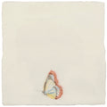 A delicate hand-painted butterfly with translucent soft yellow and white wings rests on a pastel cotton ceramic tile