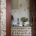 Palazzo Corsini Border grey and white floral mosaic border with a white floral vase of wildflowers