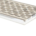 Gray circular mosaic tile with textured stone finish and white mortar border from palazzo mancini border collection