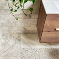 White marble palazzo oro honed marble tiles with gray veining and mosaic border on walls and floor 30.5 x 10cm