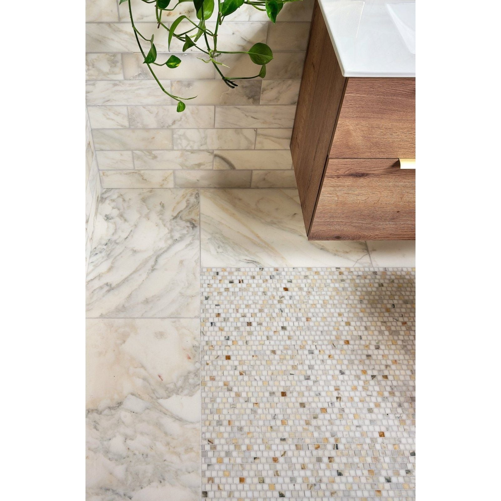 The bathroom floor features palazzo oro honed marble tiles in white with gray veining and neutral mosaic accents
