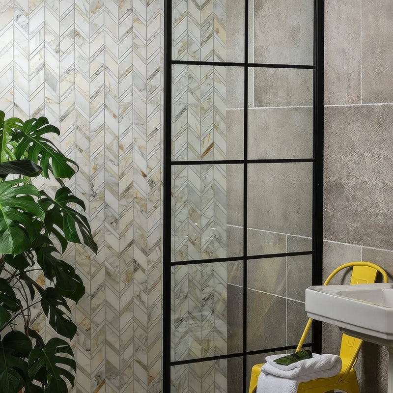 Palazzo Oro Marble Chevron Mosaic beige and grey marble chevron mosaic in a glass shower enclosure